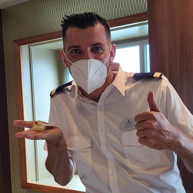 Cruise crew member with a small rubber duck.