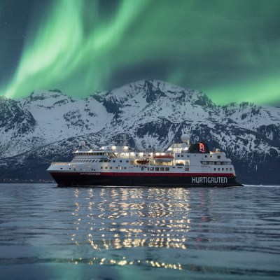 Hurtigruten cruise ship in Norway, in front of the Northern Lights