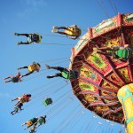 Swing ride at fair spinning around with people having funq