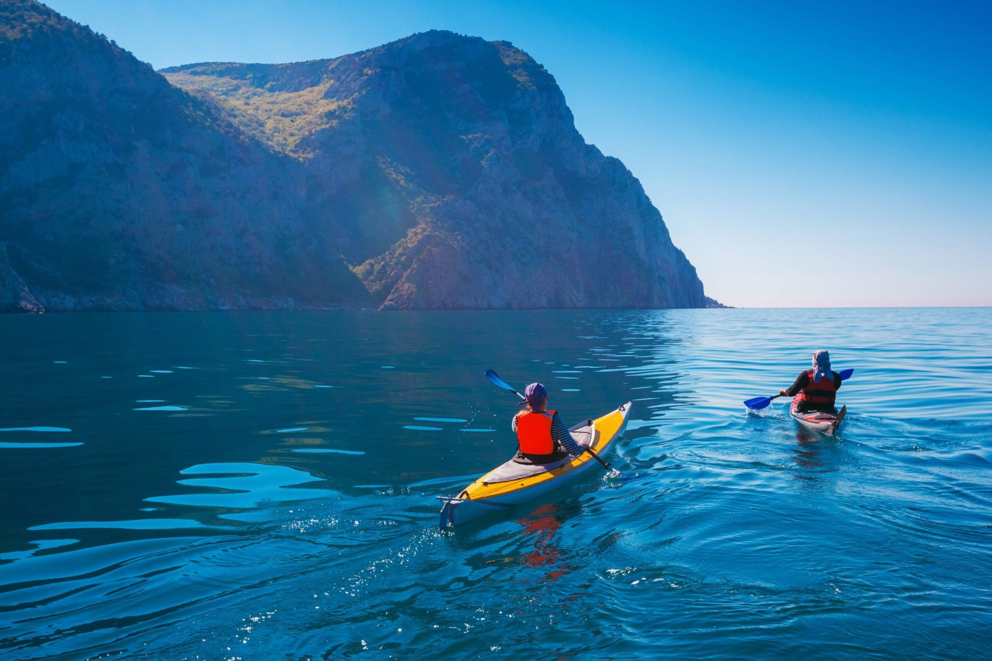 Two people kayaking in the ocean