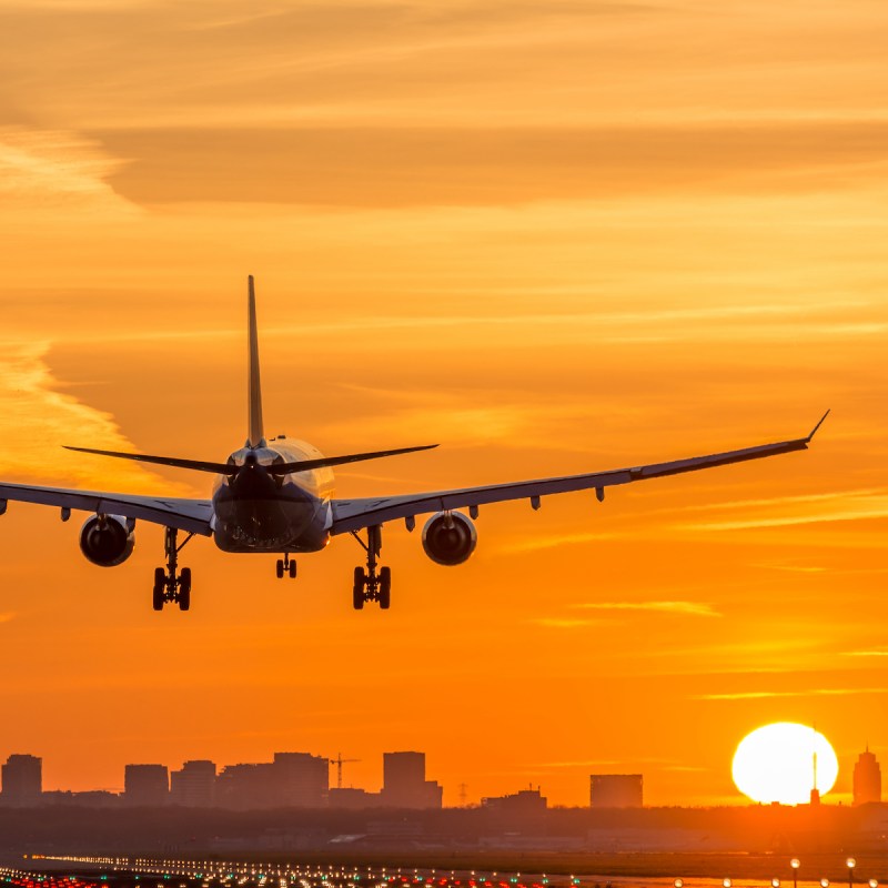 Airplane is landing during a nice early morning sunrise