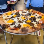 Hand-tossed premium pizza with cheese curds at Wild Tomato Wood-Fired Pizza and Grille in Fish Creek