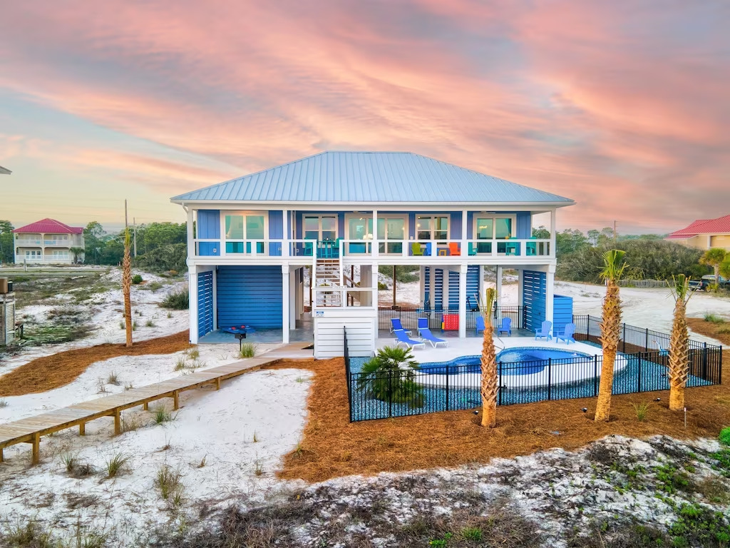blue beach house with pool at sunset st. george island