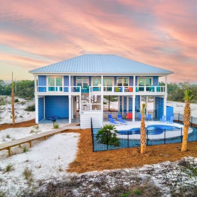blue beach house with pool at sunset st. george island