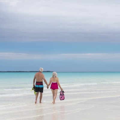 retirees walking on a beach