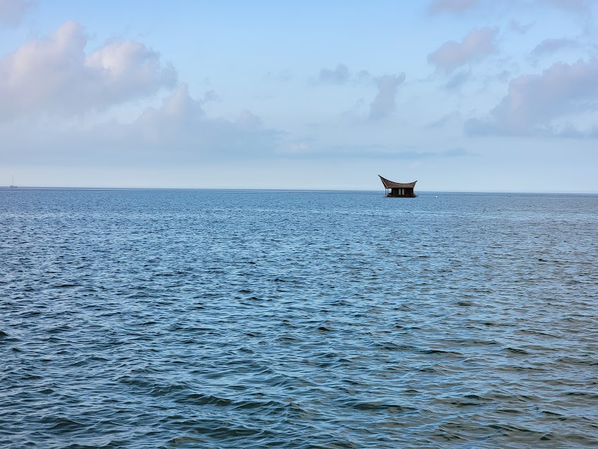 tiki suite floating on water as seen from far away