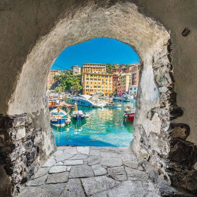 A window peeking into the colorful town of Camogli, Italy