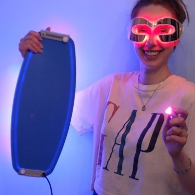 Author holding LED light therapy products