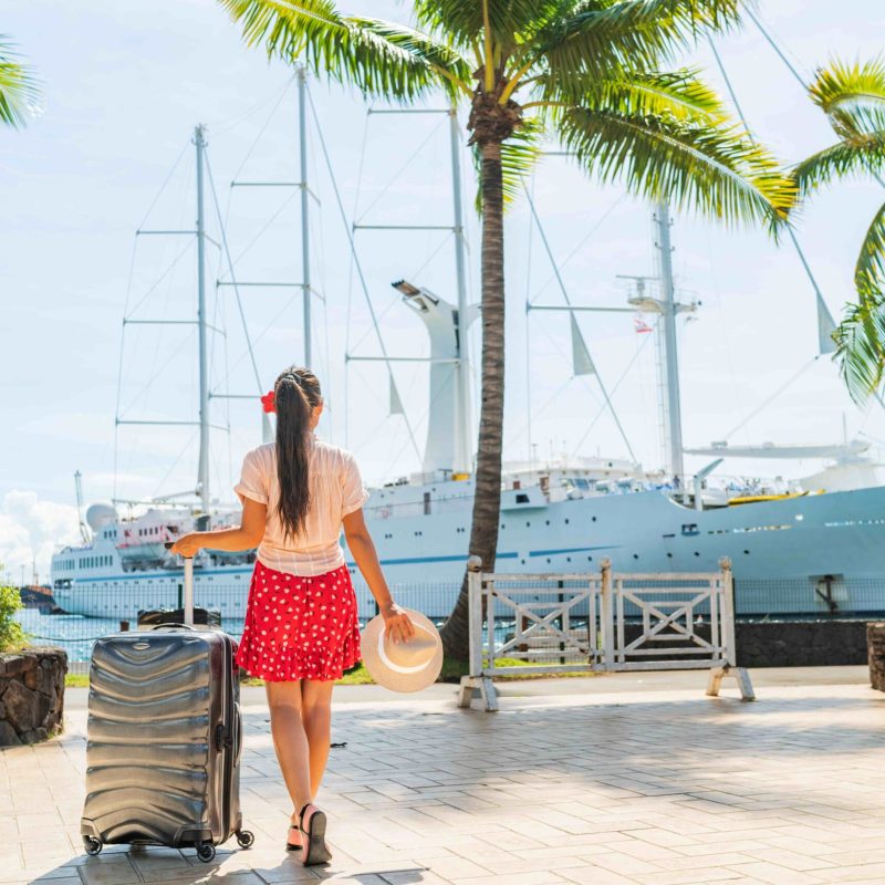Cruise traveler with suitcase going to board cruise ship