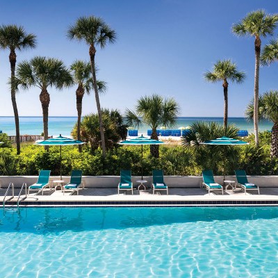 The relaxing pool and view of the pristine sand at The Resort at Longboat Key Club