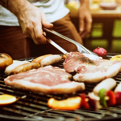 Closeup of steak barbecues cooking grilling on charcoals