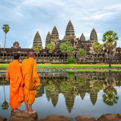 Local monks approaching Angkor Wat in Siem Reap, Cambodia