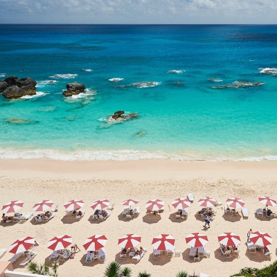 Umbrellas dot the pink-sand beach at The Reefs Club Resort & Spa.