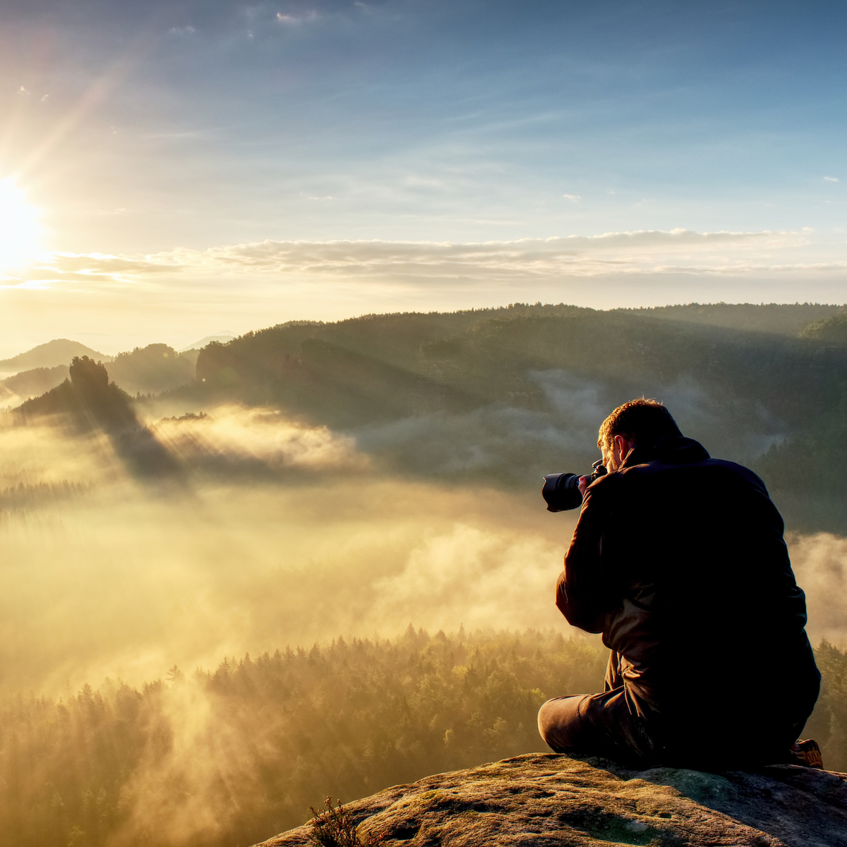 Photographer taking authentic outdoor photos in autumn landscape