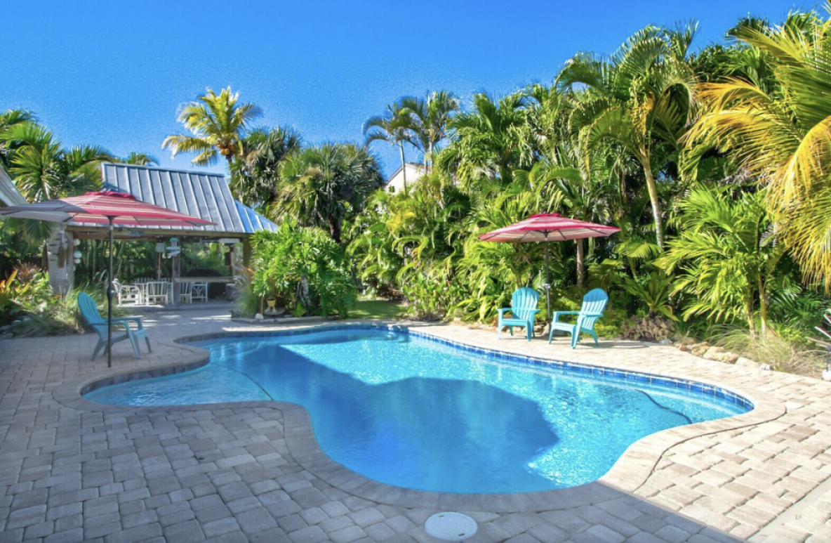 Pool view of the Island Oasis - Luxury Pool Home Steps to the Beach