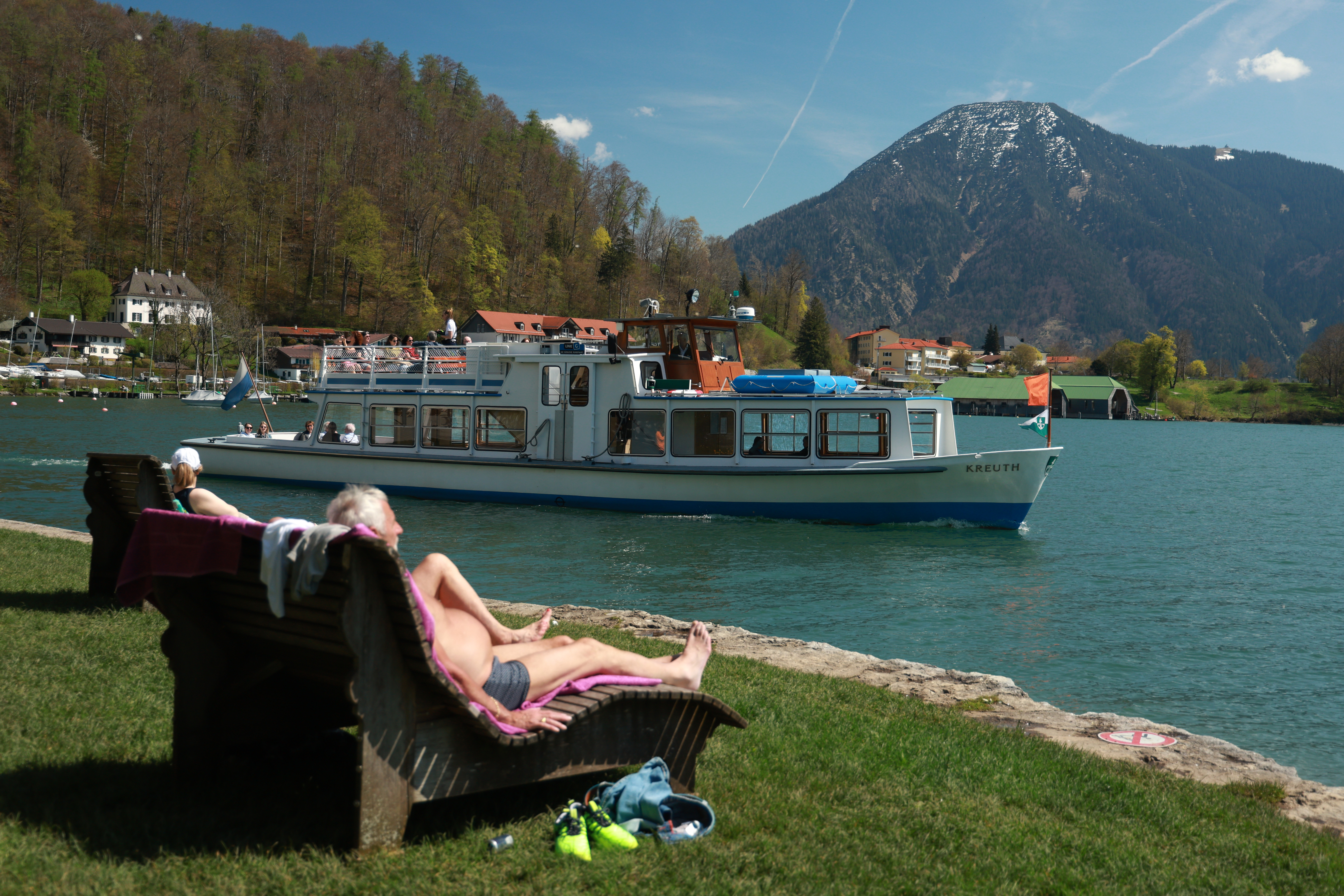 Cruise guests subathing beside a river.