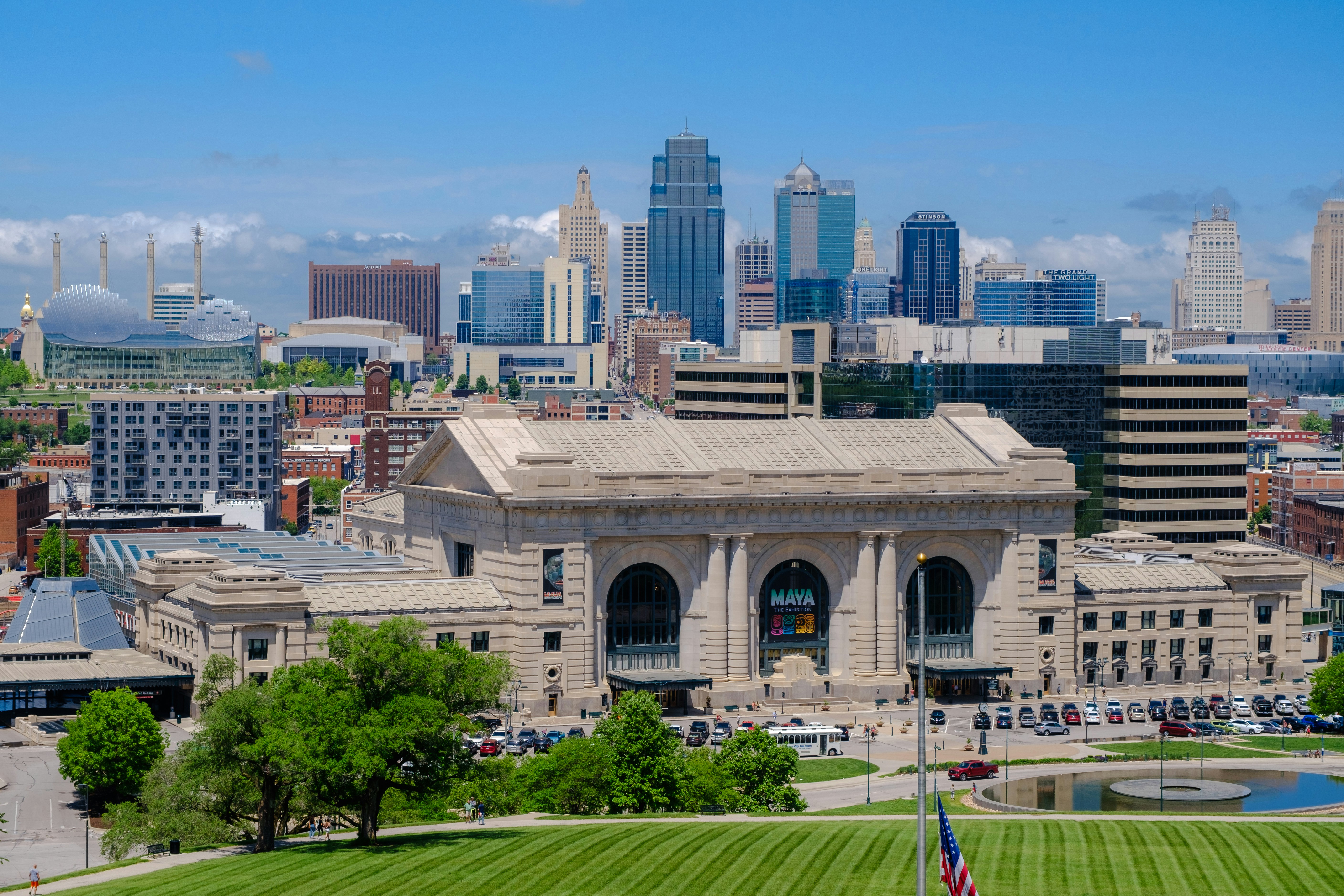 Large building with a pool in front of it with union station in the background